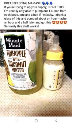 a bottle of pineapple with coconut water next to a baby bottle on a counter