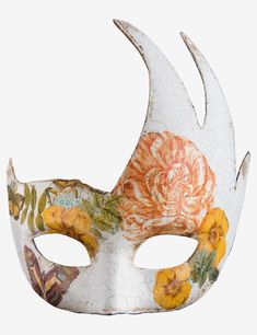 a white mask with flowers painted on the front and sides, against a white background