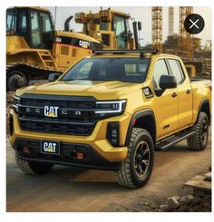 a yellow truck parked in front of construction equipment