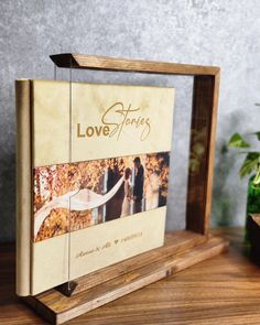 a wooden frame with an image of two people and the words love stories on it