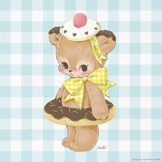 a brown teddy bear sitting on top of a donut with a cherry on it