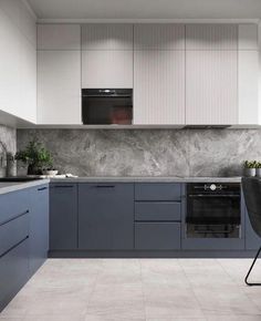 a kitchen with blue cabinets and marble counter tops is pictured in this image, there are two chairs at the table