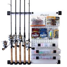 fishing rods and lures are hanging on the wall in front of a display rack