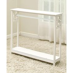 a white console table sitting on top of a carpeted floor next to a window