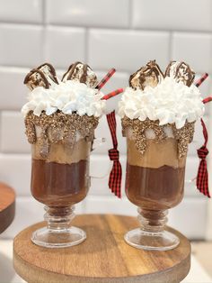 two glasses filled with hot chocolate and whipped cream