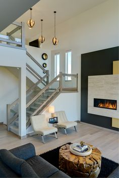 a living room with a fire place and stairs