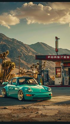 a green car parked in front of a gas station with mountains in the back ground