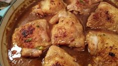 some chicken is cooking in a brown gravy