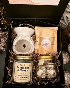 an open gift box containing cookies, marshmallows and other things to put in it