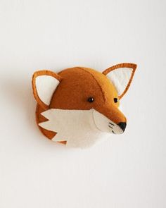 a felt fox head hanging on the wall