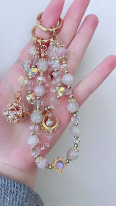 a hand holding several different bracelets on it's palm with charms attached to them