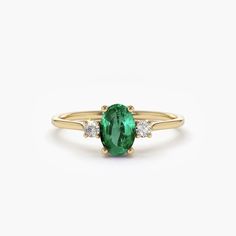 This stunning 14k oval shape emerald and diamond 3 stone ring is the perfect accessory for any occasion. The deep green emerald stone is nestled between two dazzling diamonds, creating a stunning contrast that catches the eye. The 14k gold band adds a touch of sophistication and elegance, making this ring a timeless piece that will never go out of style. With its classic design and high-quality materials, this ring is sure to become a treasured addition to any jewellery collection. Perfect for engagements, anniversaries, or any other special occasion, this ring is a true statement piece that will impress anyone who sees it.Details	Made to Order	Gold Kt: 14K (also available in 14k)	Available Gold Color: Rose Gold, Yellow Gold, White Gold	Oval Emerald: 1 pc 6x4MM	Roun Diamond: 2 pcs 2.0 MM	N Unconventional Engagement Rings, Dream Engagement Ring, 3 Stone Ring, Sapphire Engagement Rings, Cute Engagement Rings, Silver Diamond Ring, Emerald Rings, Engagement Ring Ideas, 3 Stone Rings