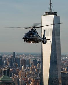 a helicopter is flying over the city and skyscrapers