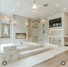 a large white bathroom with gold accents