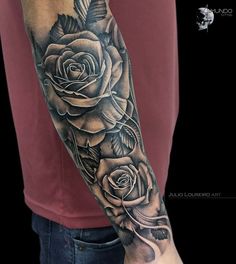 a man with a rose tattoo on his arm