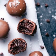 four chocolate truffles with one cut in half