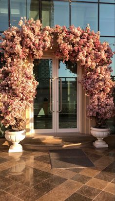 an entrance to a building with flowers on it