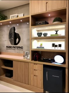 the interior of a modern kitchen with wood cabinets and shelving units, including a dishwasher