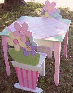 two children's table and chairs with flowers painted on them