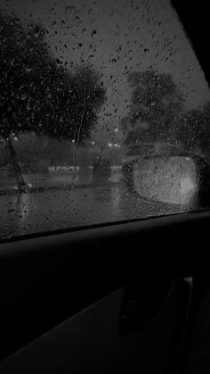 the rain is falling down on the windshield