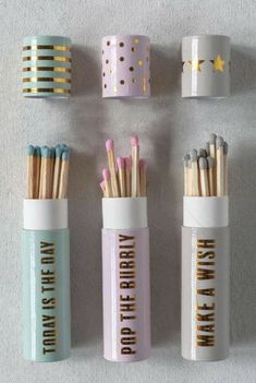 four different types of matchesticks are lined up on the wall with gold foil lettering