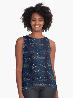 a woman wearing a blue top with stars and the words christmas written on it in gold