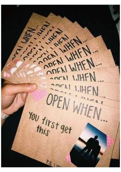 someone is holding up some cards with the words open when you first get this