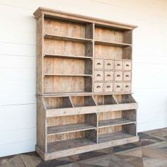 an old wooden bookcase with drawers on it