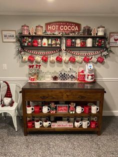 a coffee bar is decorated with christmas decorations and hot cocoa signs on the wall above it