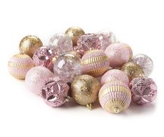 pink and gold ornaments are piled on top of each other, with glitter decorations in the middle