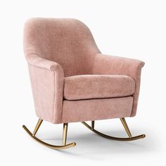 a pink rocking chair with gold legs