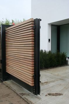 a large wooden gate on the side of a building