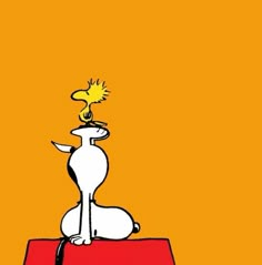 a cartoon dog sitting on top of a red box with a yellow light above it