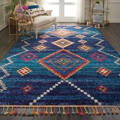 a living room with a large blue rug on the floor