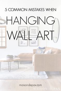 a living room with the words 5 common mismats when hanging wall art in black and white