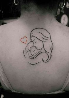 a woman with a tattoo on her back holding a baby in her arms and heart