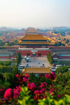 an aerial view of the forbidden city with flowers in bloom and buildings on either side