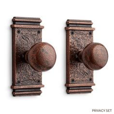 two antique style door knobs on a white background