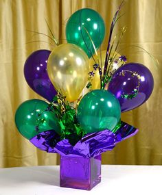 a purple vase filled with lots of balloons