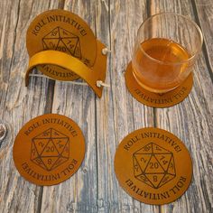 three coasters and a glass on a wooden table