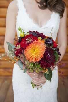 a woman holding a bouquet of flowers in her hands