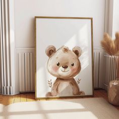 a painting of a teddy bear in a frame on the floor next to a plant