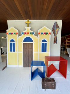 three colorful chairs sitting in front of a church