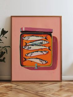 there is a painting on the wall with small fish in an orange container next to a potted plant