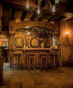 an old fashioned bar with stools and wooden walls