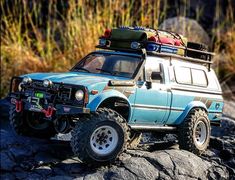 a toy truck is sitting on some rocks