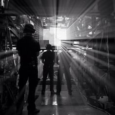 two people standing in front of a large room with sunlight coming through the window and floor