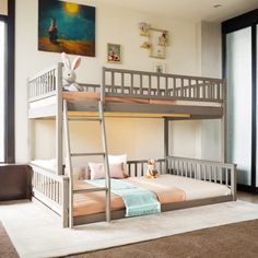 a bedroom with bunk beds and a rug on the floor