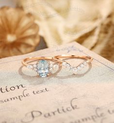 two wedding rings sitting on top of a piece of paper