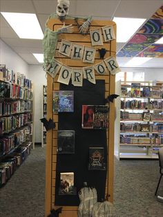 there is a sign that says oh the horror on it in front of bookshelves